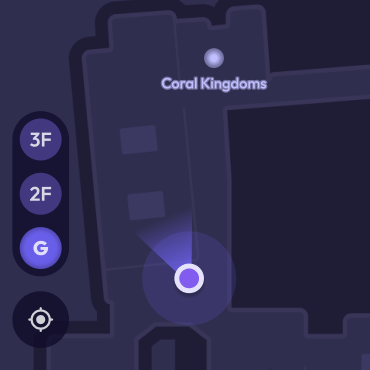 An indoor map with purple dot indicating location. There is a floor selector menu and a pin that reads "Coral Kingdom"