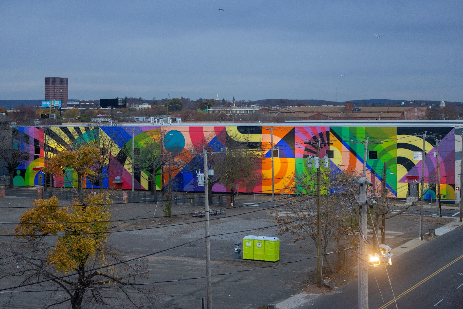 Large multi-colored painted mural on the side of a buliding